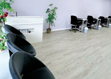 Modern interior of Violetta Beauty Studio in White Plains, New York, US with stylish seating and nail stations.