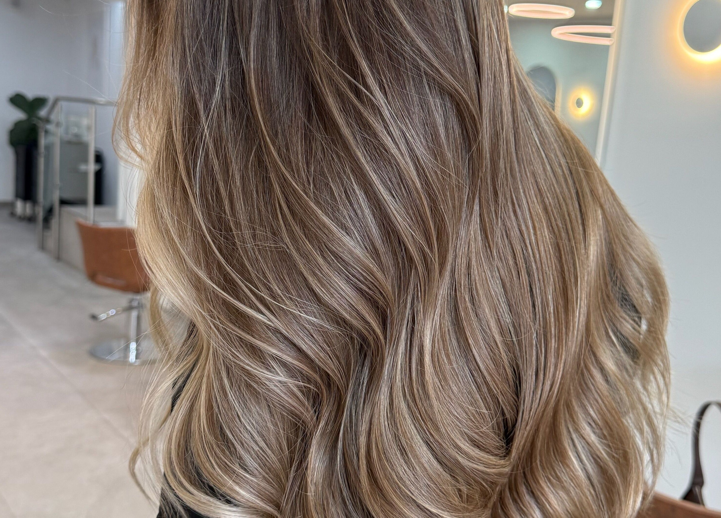 Elegant wavy hairstyle at Mane Painters salon, Kingsgrove, NSW, AU, showcasing modern beauty service.