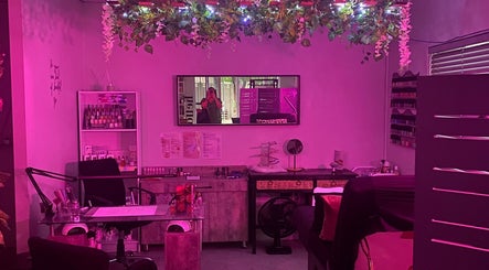 Charming interior of Xquisite Nails in Bloemfontein, Free State, ZA, featuring vibrant pink lighting and decor.