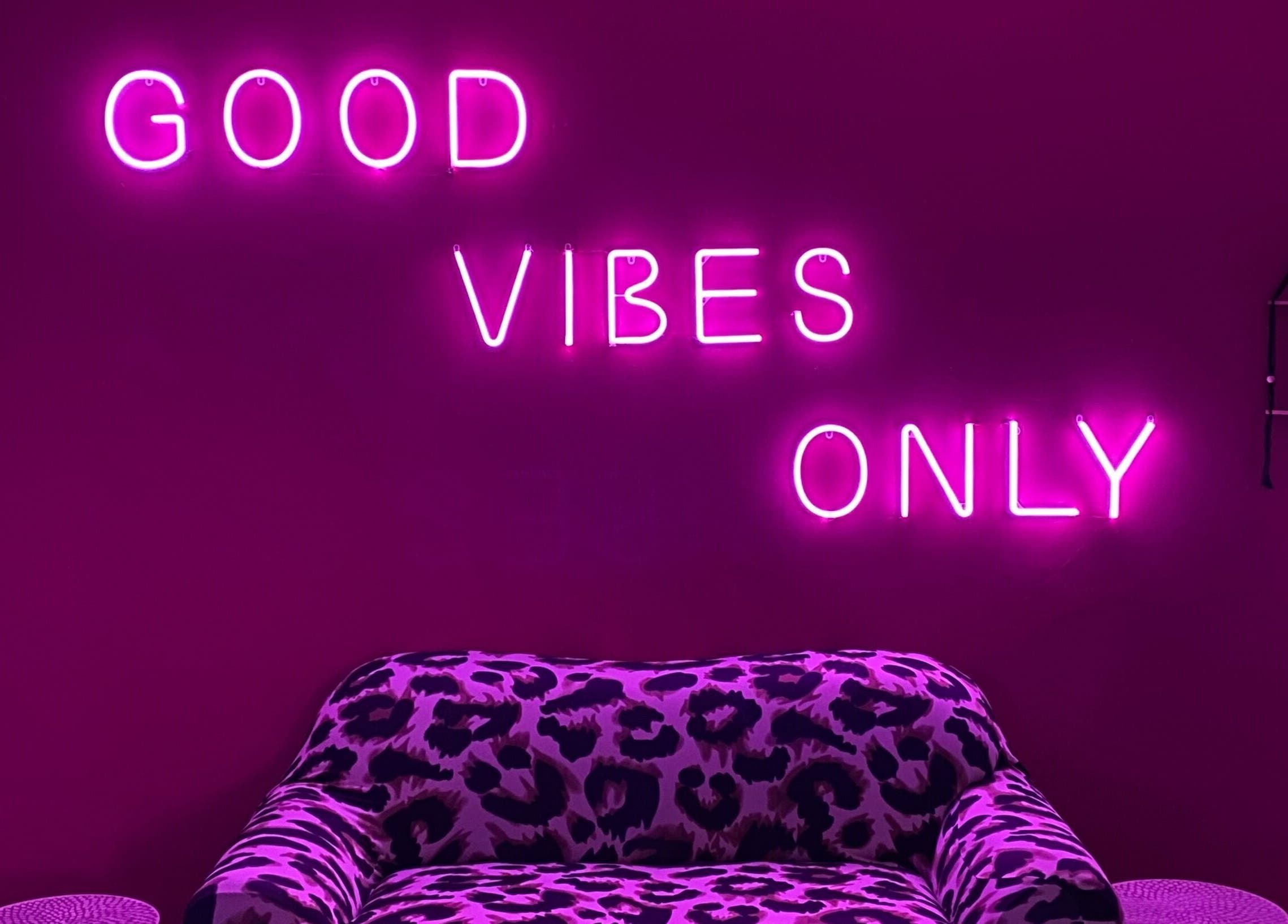 Chic leopard sofa with neon sign 'Good Vibes Only' at Xquisite Nails, Bloemfontein, Free State, ZA.