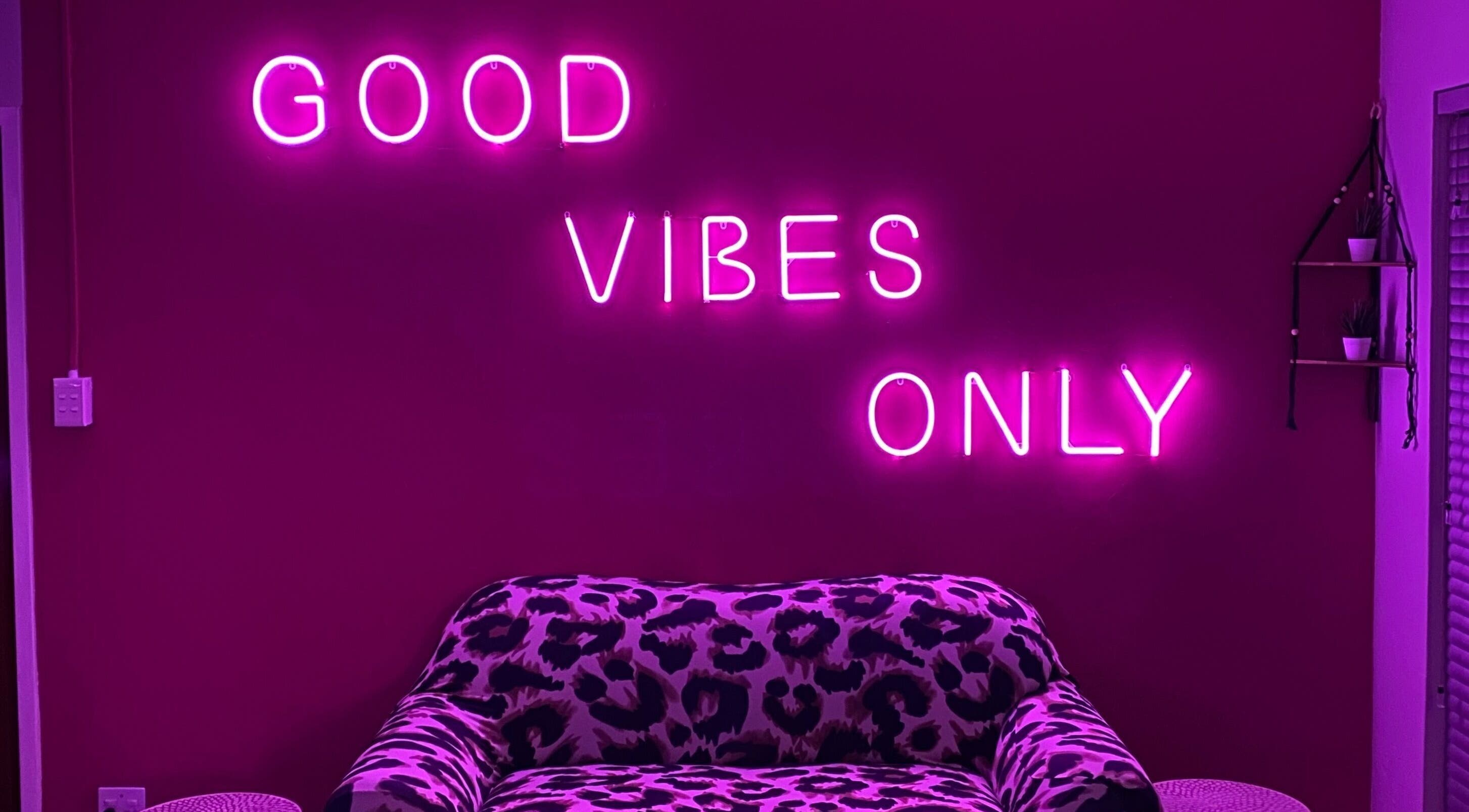 Chic leopard sofa with neon sign 'Good Vibes Only' at Xquisite Nails, Bloemfontein, Free State, ZA.