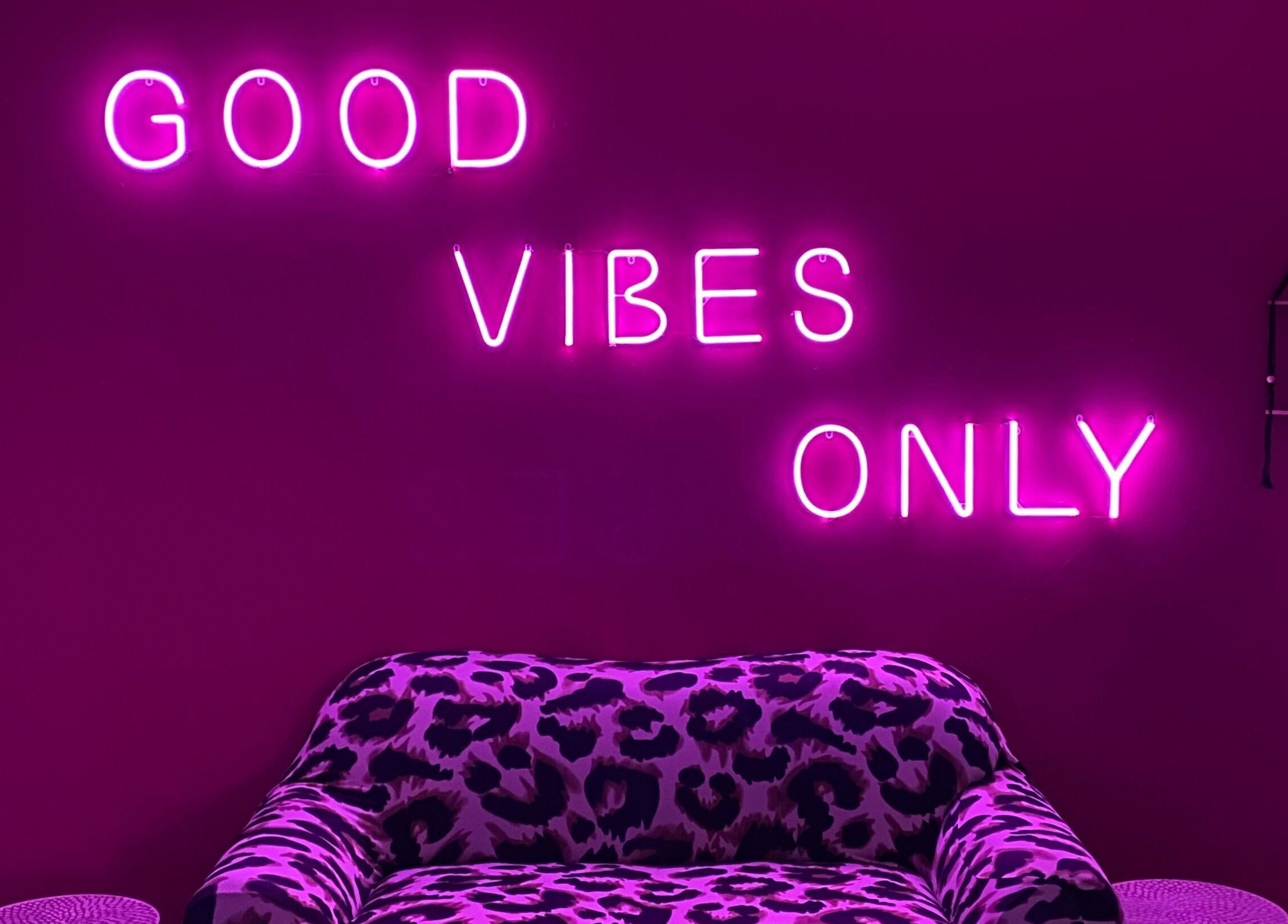 Stylish lounge with neon 'Good Vibes Only' at Xquisite Nails, Bloemfontein, Free State, ZA.