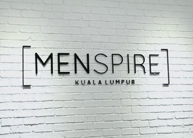 Menspire Kuala Lumpur logo on white brick wall, KUALA LUMPUR, WILAYAH PERSEKUTUAN KUALA LUMPUR, MY.