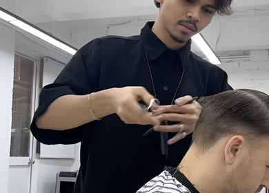 Hair stylist at Menspire Kuala Lumpur crafting a sleek look. KUALA LUMPUR, WILAYAH PERSEKUTUAN KUALA LUMPUR, MY.