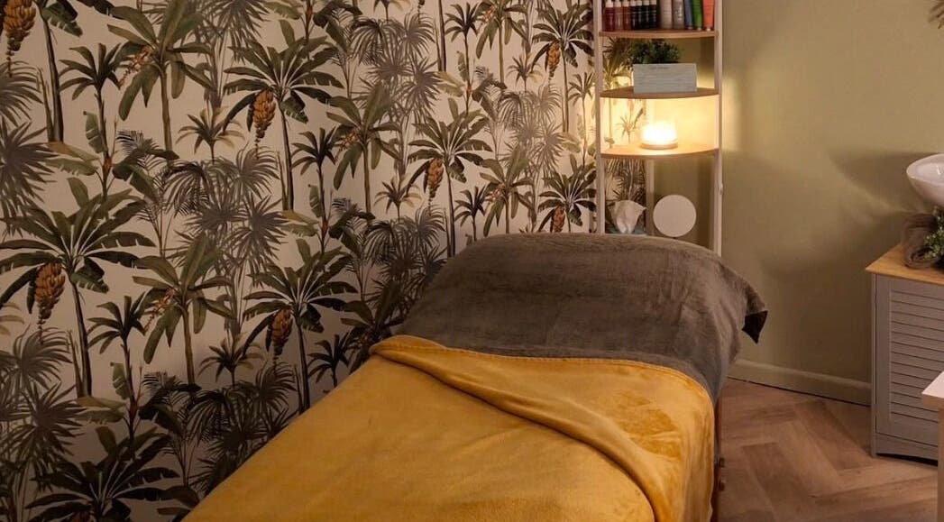 Relaxing massage room at Blubell Nails and Beauty in Rode Heath, England, GB with tropical wallpaper and cozy bed.