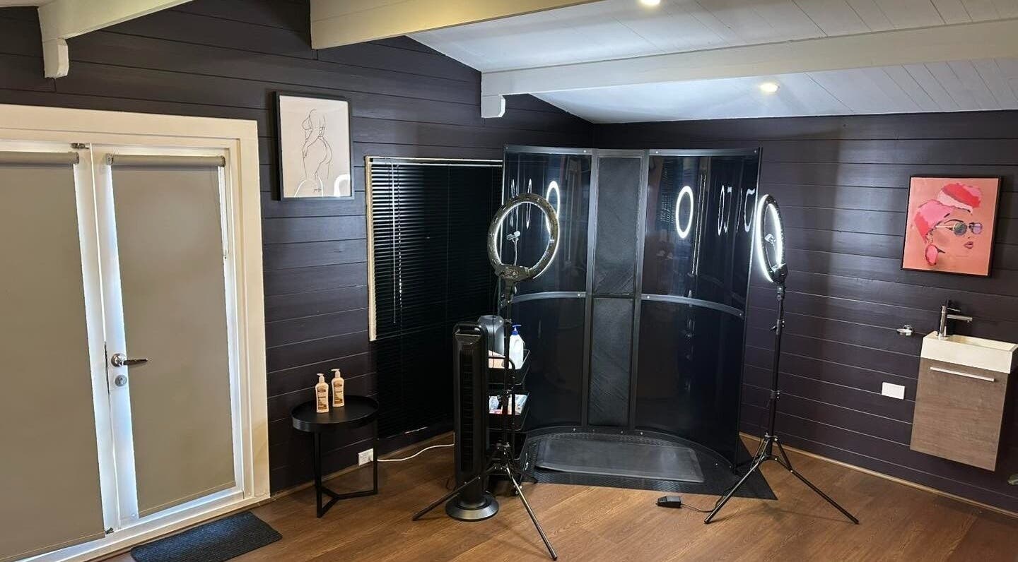 Interior of Bronzed Body Spray Tan Studio at Port Kennedy, WA featuring modern decor and tanning equipment.