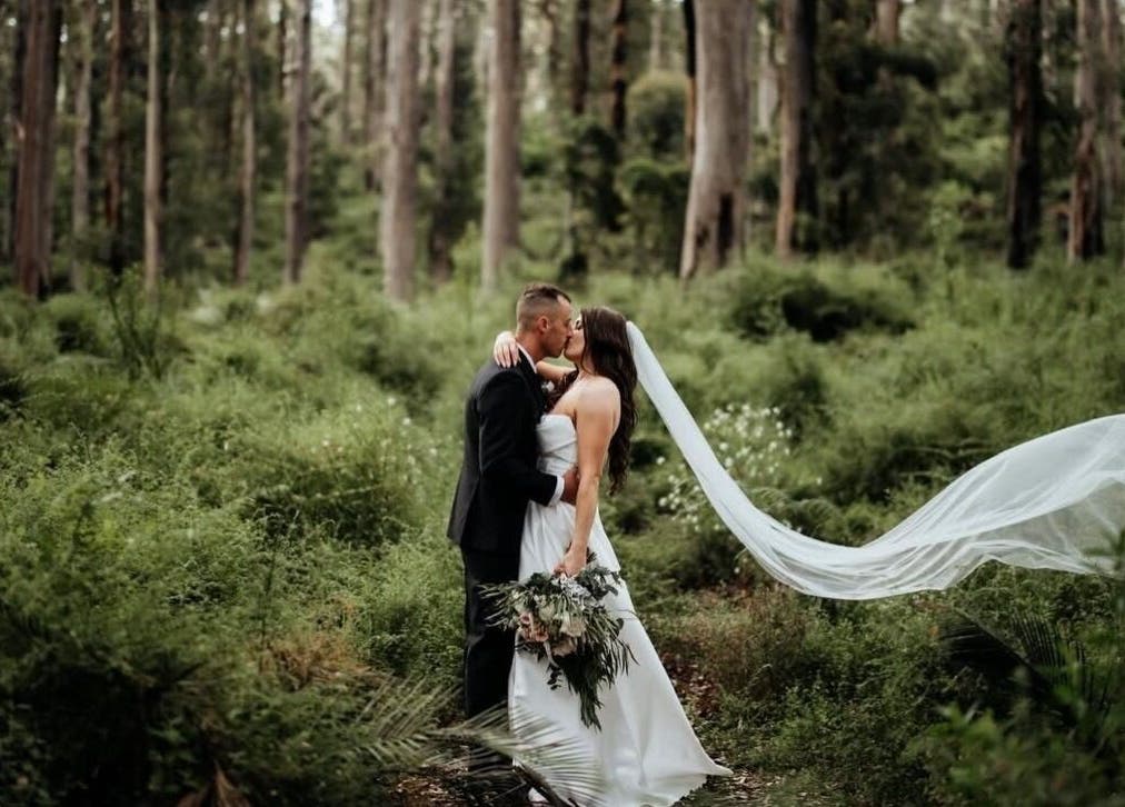 A couple embraces in a lush forest at Bronzed Body Spray Tan Studio, Port Kennedy, Western Australia, AU.