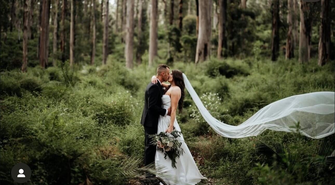A couple embraces in a lush forest at Bronzed Body Spray Tan Studio, Port Kennedy, Western Australia, AU.
