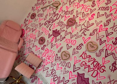 Vibrant therapy room at Beauty and Aesthetics Lodge, London Colney, England, GB, with pink decor and chic wall art.