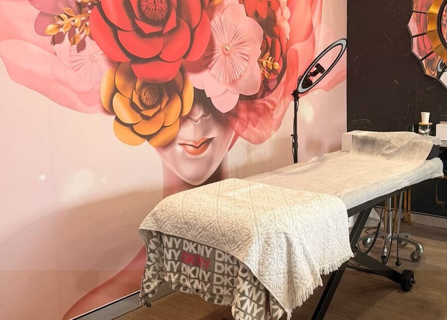 Massage table at Roshy Eyelash Extensions & Brows Norwest, Baulkham Hills, New South Wales, AU with floral decor.