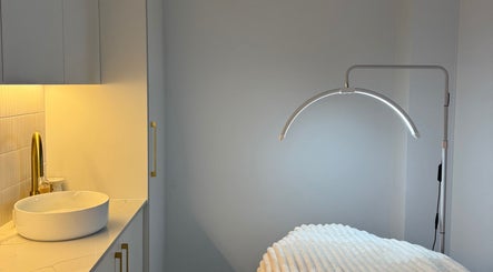 Elegant treatment room at Fabulash, Burleigh Waters, Queensland, AU, featuring modern lighting and decor.