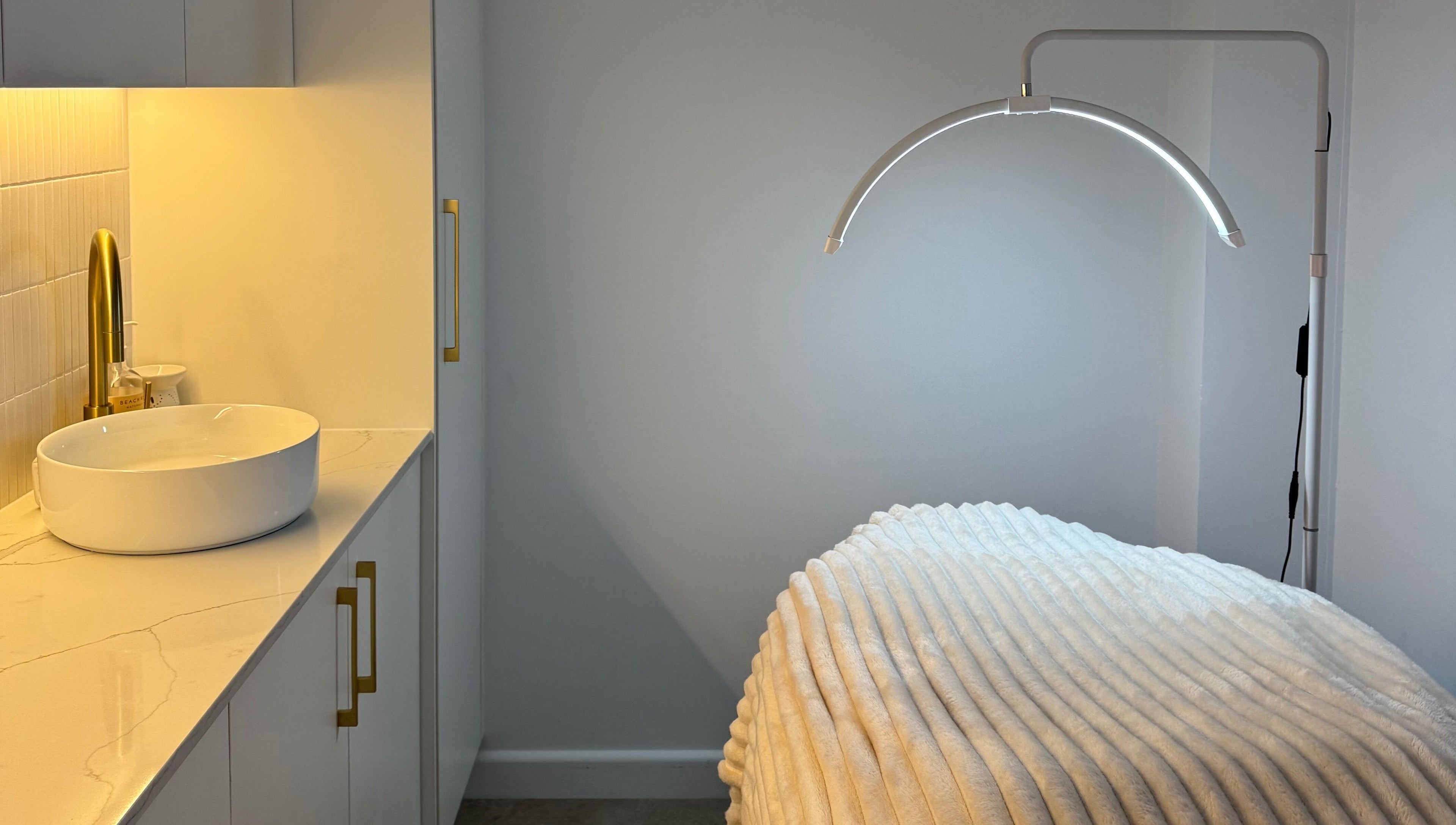 Tranquil treatment room at Fabulash, Burleigh Waters, Queensland, AU with cozy bed and modern decor.