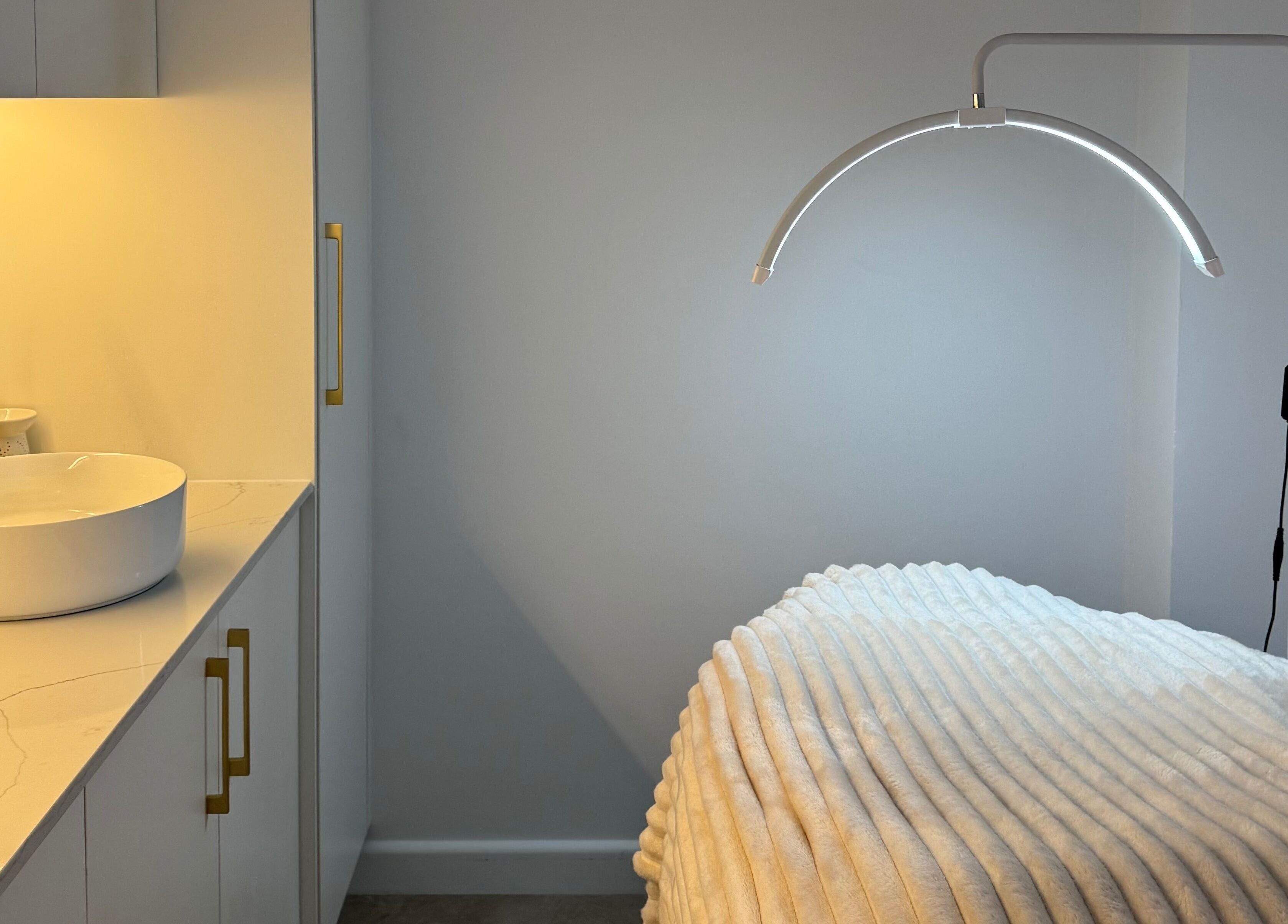 Tranquil treatment room at Fabulash, Burleigh Waters, Queensland, AU with cozy bed and modern decor.