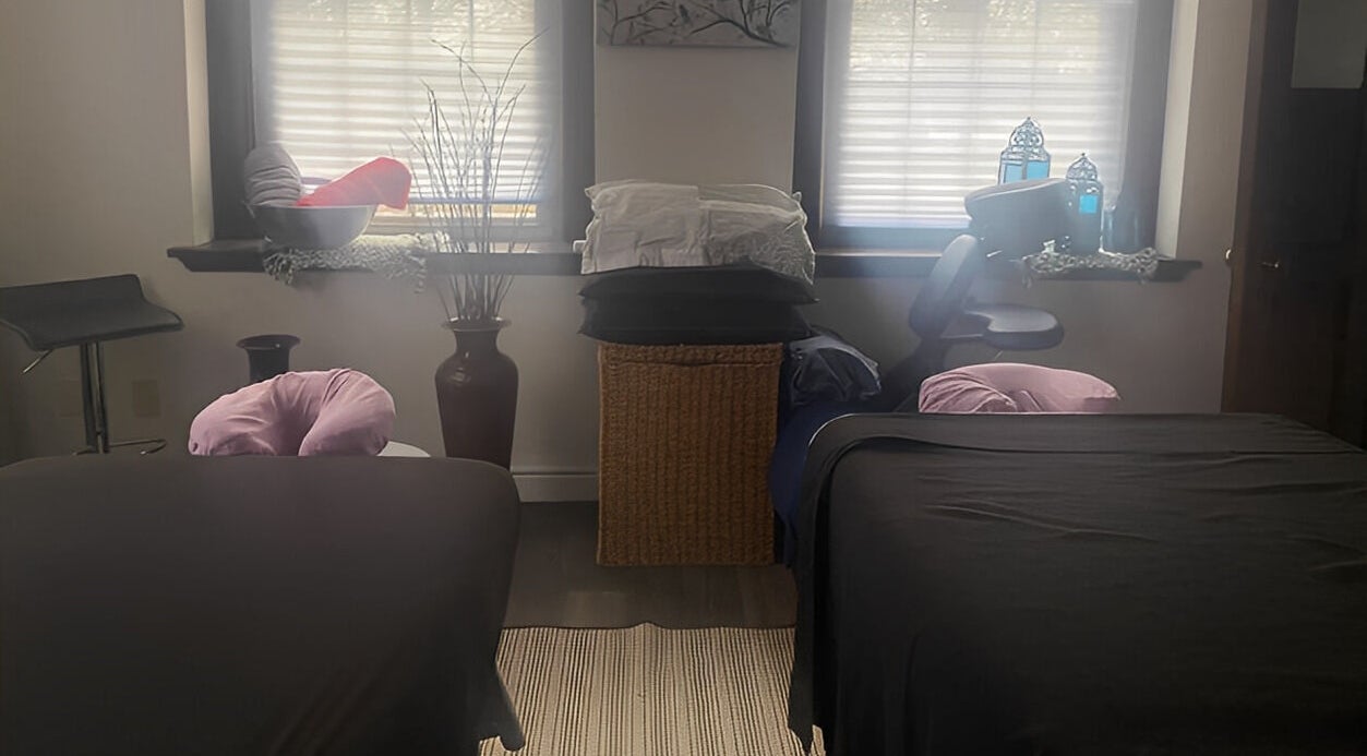 Peaceful massage room at New Beginnings Spa Services in Lansing, Michigan, US, highlighted by soft lighting.