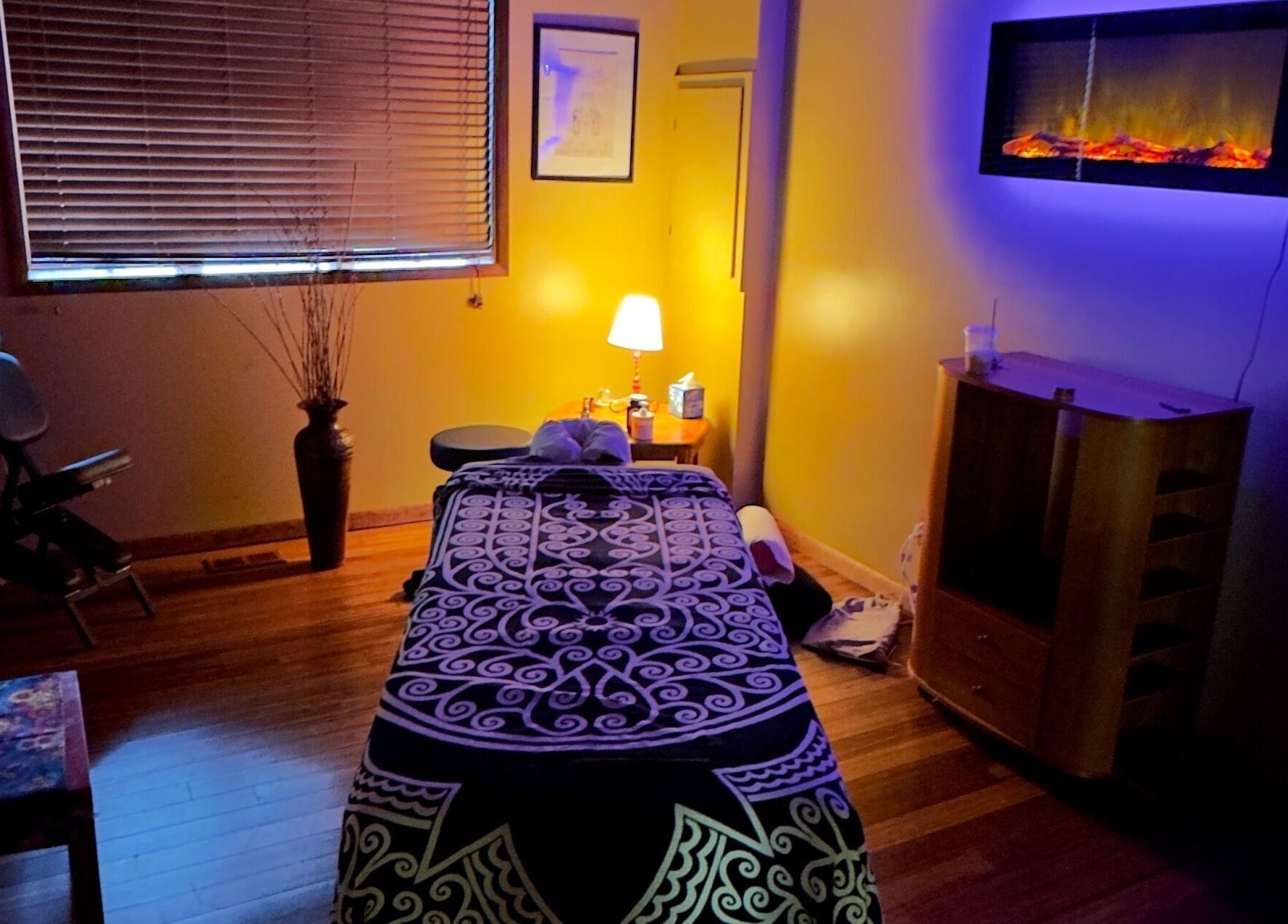 Cozy massage room at New Beginnings Spa Services, Lansing, Michigan, with ambient lighting and relaxing decor.