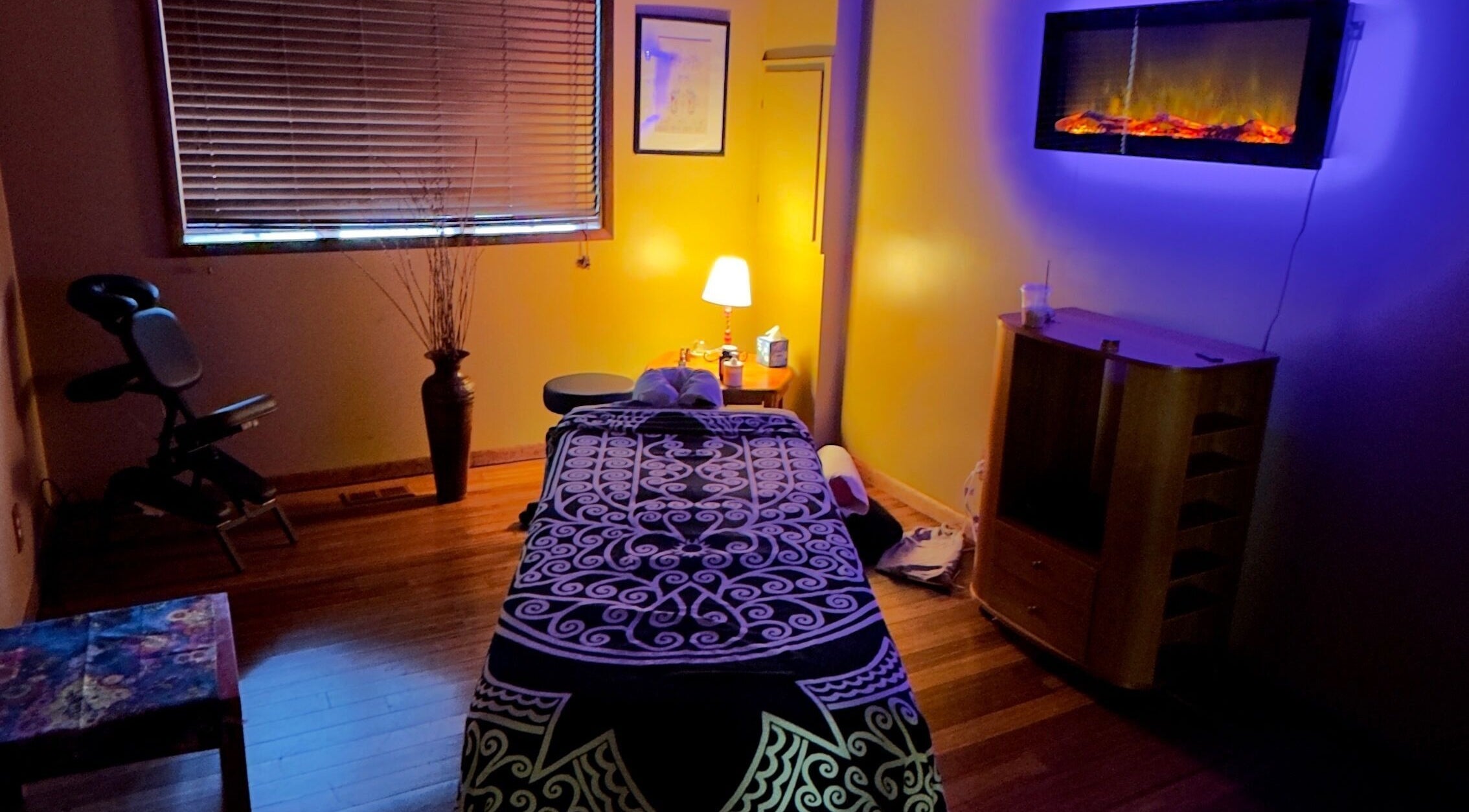 Cozy massage room at New Beginnings Spa Services, Lansing, Michigan, with ambient lighting and relaxing decor.