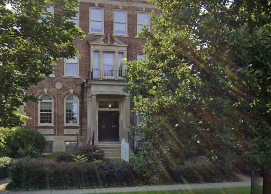 Charming exterior of New Beginnings Spa Services located in Lansing, Michigan, US surrounded by lush greenery.