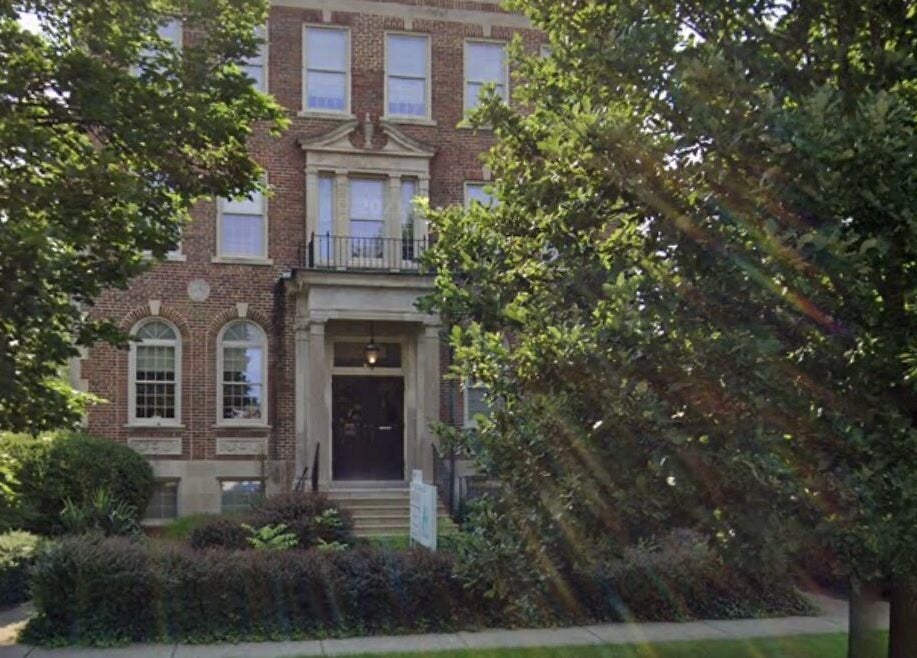 Charming exterior of New Beginnings Spa Services located in Lansing, Michigan, US surrounded by lush greenery.