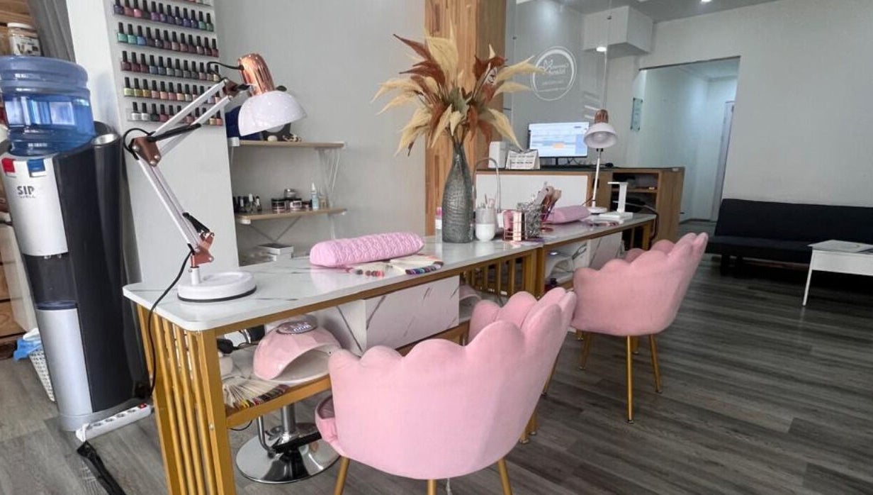 Nail salon interior at Cosmetic Island Port Louis with pink chairs, desk, and decor, Port Louis District, MU.