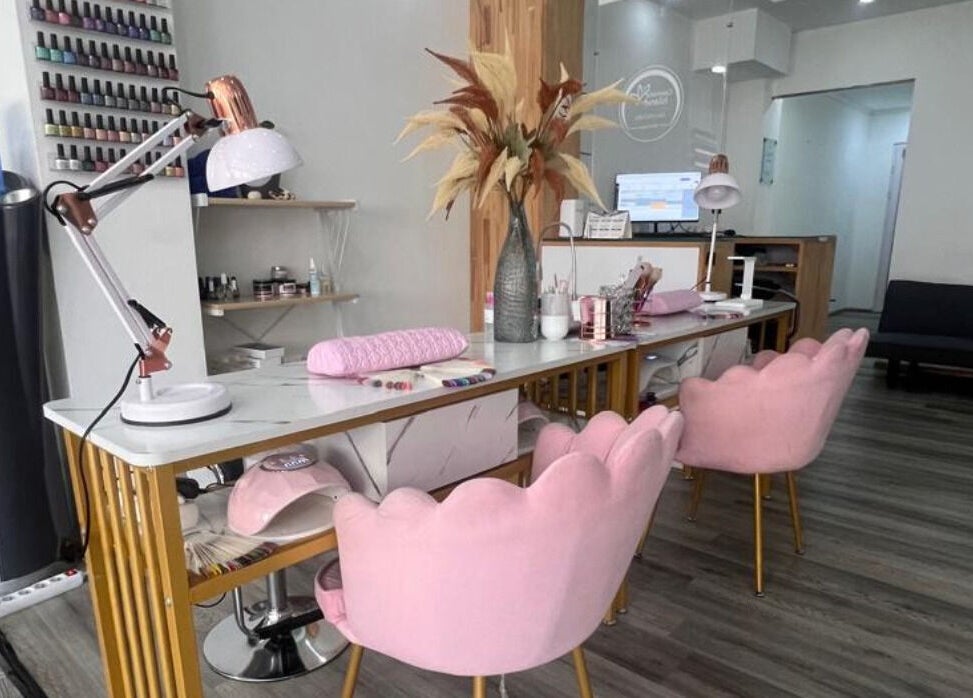 Nail salon interior at Cosmetic Island Port Louis with pink chairs, desk, and decor, Port Louis District, MU.