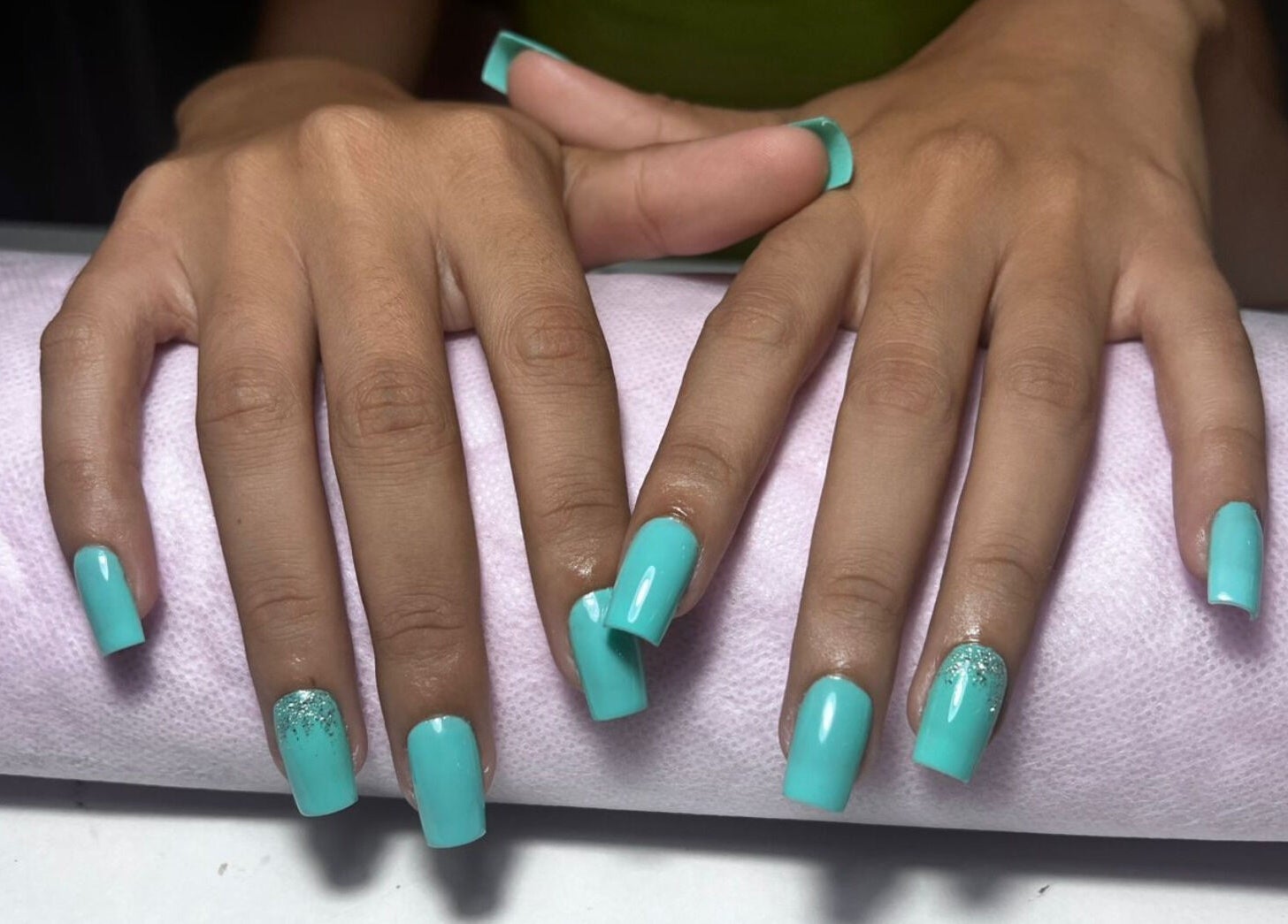 Elegant aqua nails manicure at Cosmetic Island Port Louis, Port Louis District, MU on soft pink towel.