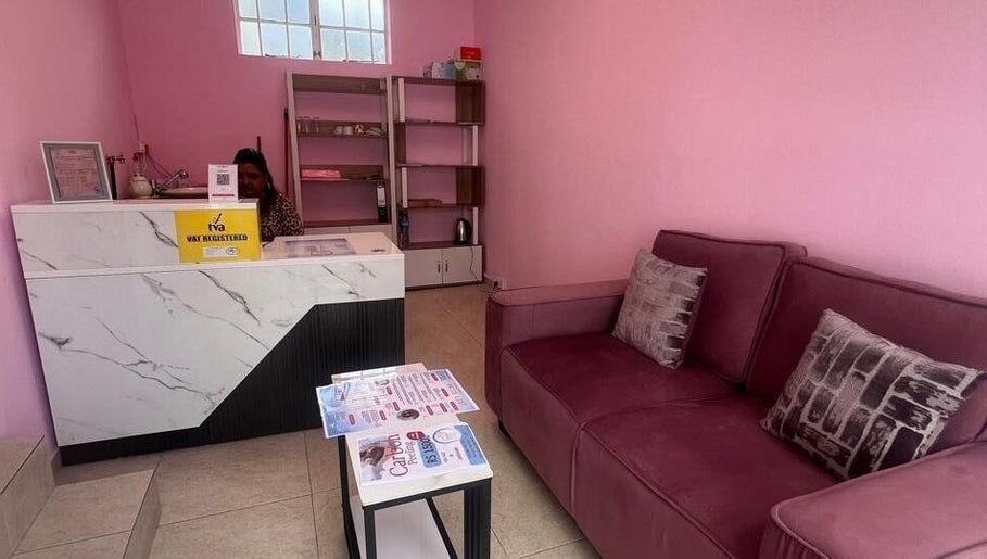 Cozy reception area at Cosmetic Island Quatre Bornes, Quatre Bornes, Plaines Wilhems District, MU with pink walls.