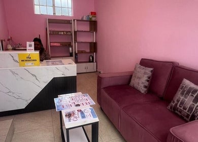 Cozy reception area at Cosmetic Island Quatre Bornes, Quatre Bornes, Plaines Wilhems District, MU with pink walls.