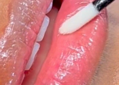 Glossy lips being applied at Inv Beauty Bar, Toronto, Ontario, CA, showcasing expert beauty care.