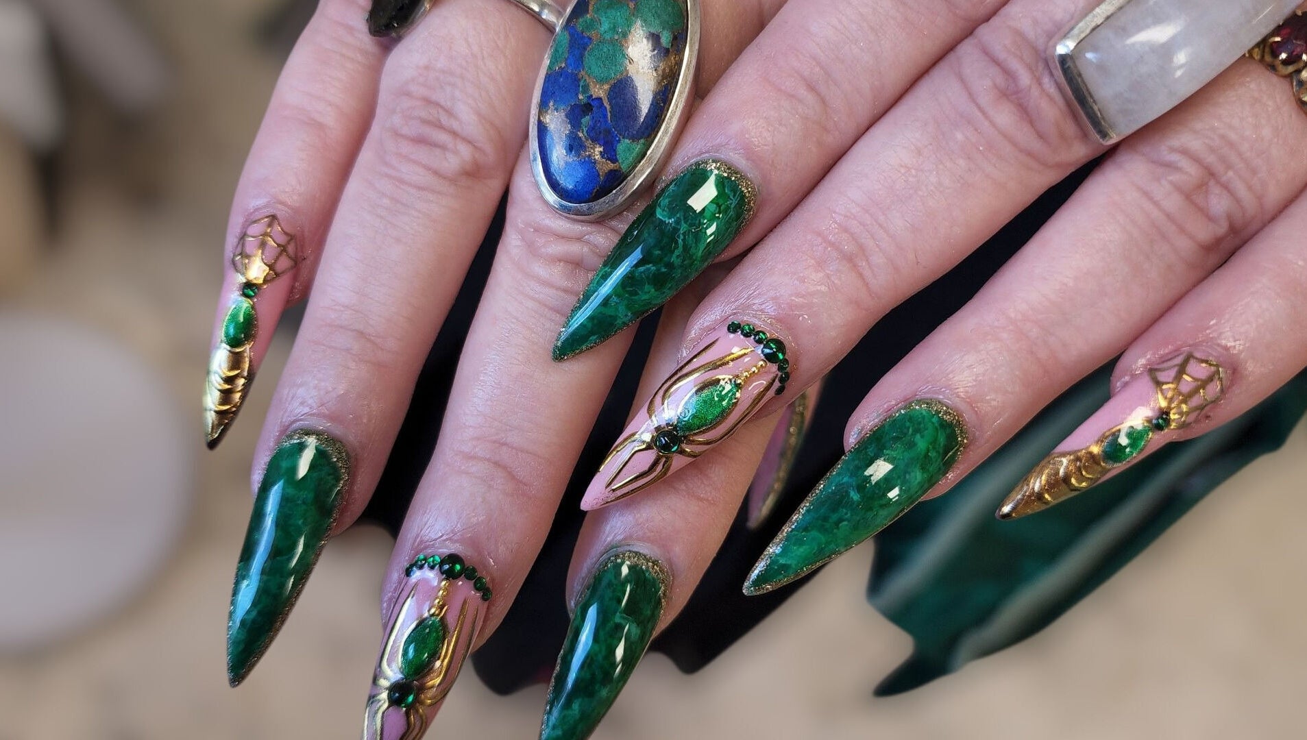 Intricate emerald nail art at Hey Nails by Winn, Benowa, Queensland, AU, showcasing vibrant green designs.