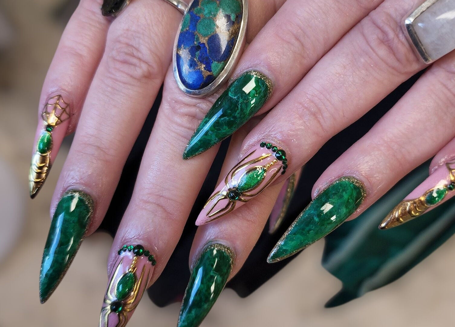 Intricate emerald nail art at Hey Nails by Winn, Benowa, Queensland, AU, showcasing vibrant green designs.