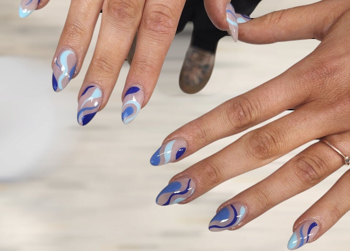 Stylish blue swirl nail art at Hey Nails by Winn in Benowa, Queensland, AU showcasing creativity and elegance.