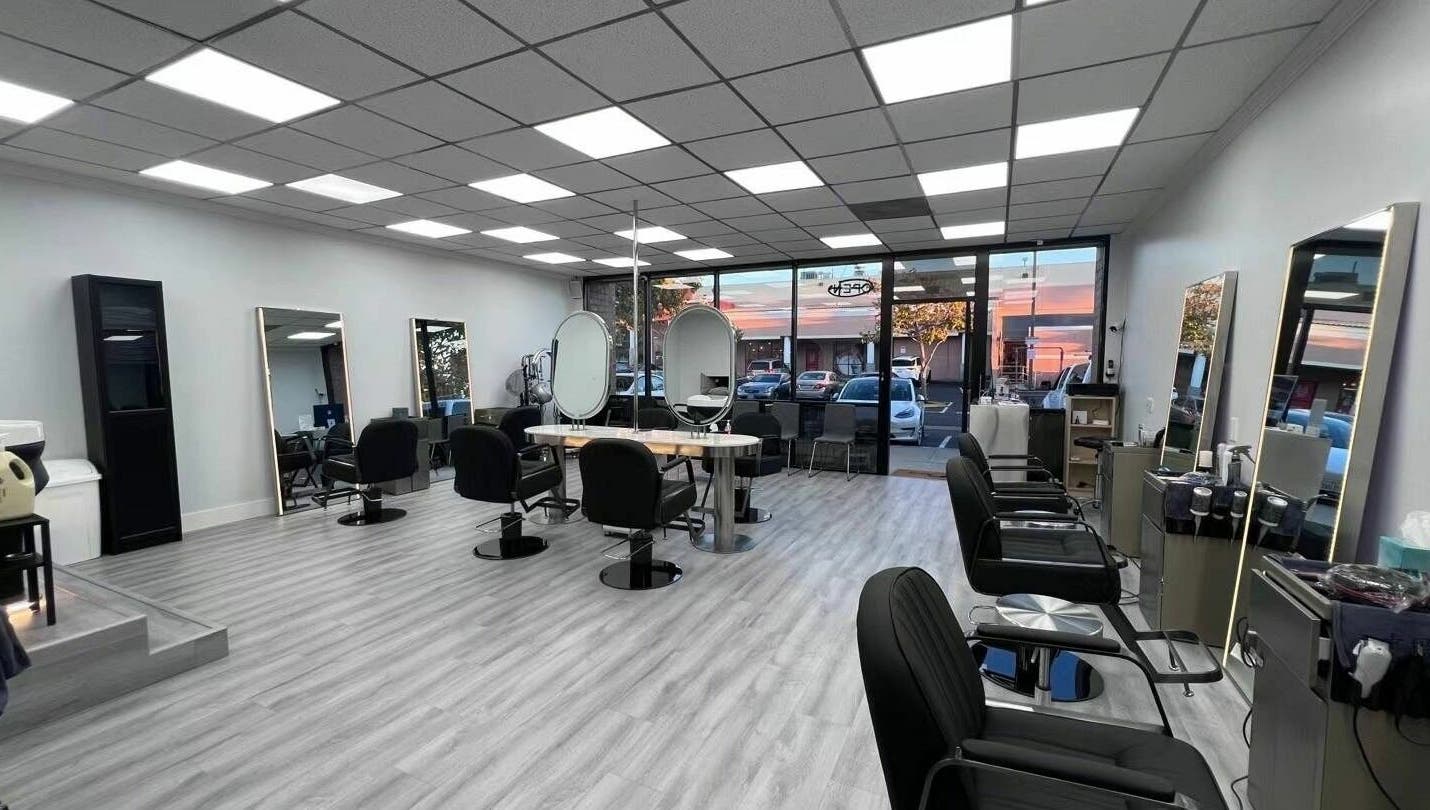 Modern and chic interior of K MA Salon Convoy in San Diego, California, US, featuring sleek styling stations.