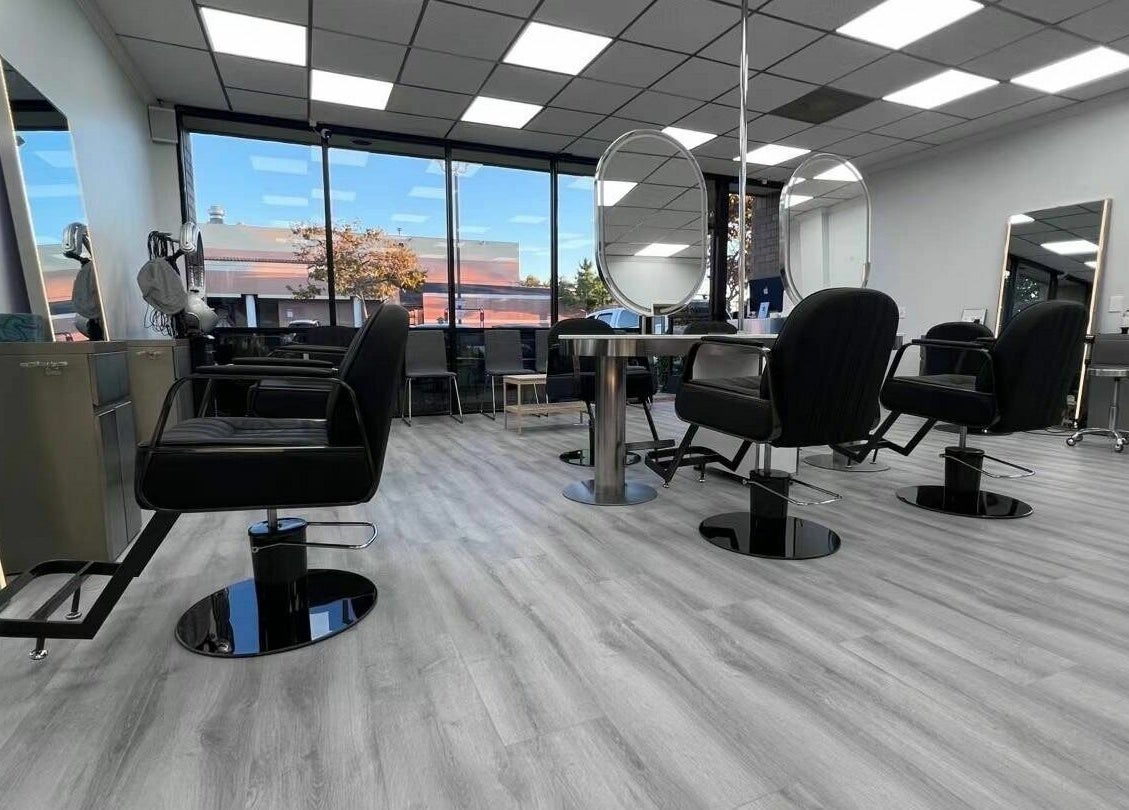 Chic interior of K MA Salon Convoy in San Diego, California, US, showcasing modern salon chairs and mirrors.