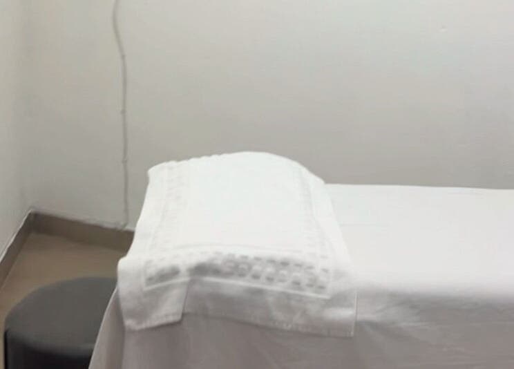 Cozy massage room at Nails&Beauty by Busie, Johannesburg, Gauteng, ZA. White linens on treatment table.