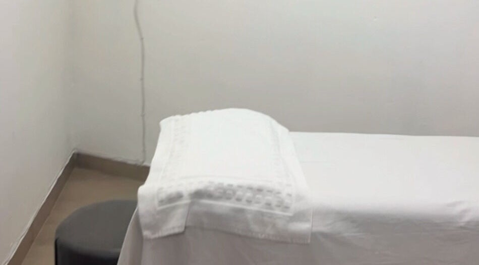 Cozy massage room at Nails&Beauty by Busie, Johannesburg, Gauteng, ZA. White linens on treatment table.