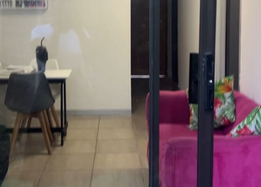 Cozy lounge at Nails&Beauty by Busie, Johannesburg, Gauteng, ZA featuring vibrant pink sofa and stylish decor.