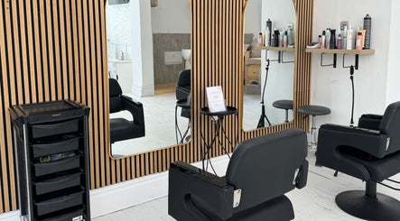 Modern salon interior at Calma Salons- Altrincham, featuring stylish black chairs in Altrincham, England, GB.