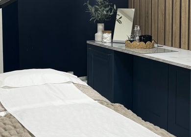 Relaxing treatment room at Calma Salons- Altrincham with cozy bed, elegant decor in Altrincham, England, GB.