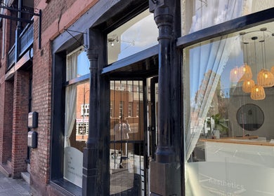 Exterior of Calma Salons- Altrincham, showcasing elegant signage and inviting window displays in Altrincham, England, GB.