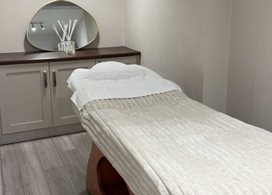 Relaxing spa treatment room at calma salons - Chester, Chester, England, GB. Elegant decor with a comfortable bed.