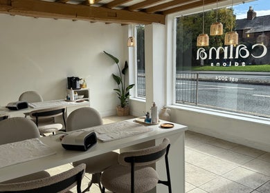 Interior of calma salons - Chester, showcasing modern nail stations by a large window in Chester, England, GB.