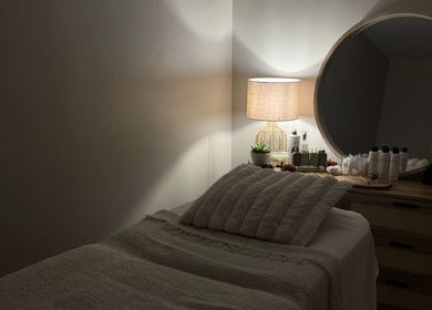 Cozy treatment room at calma salons - Chester, featuring plush bedding and ambient lighting. Located in Chester, England, GB.