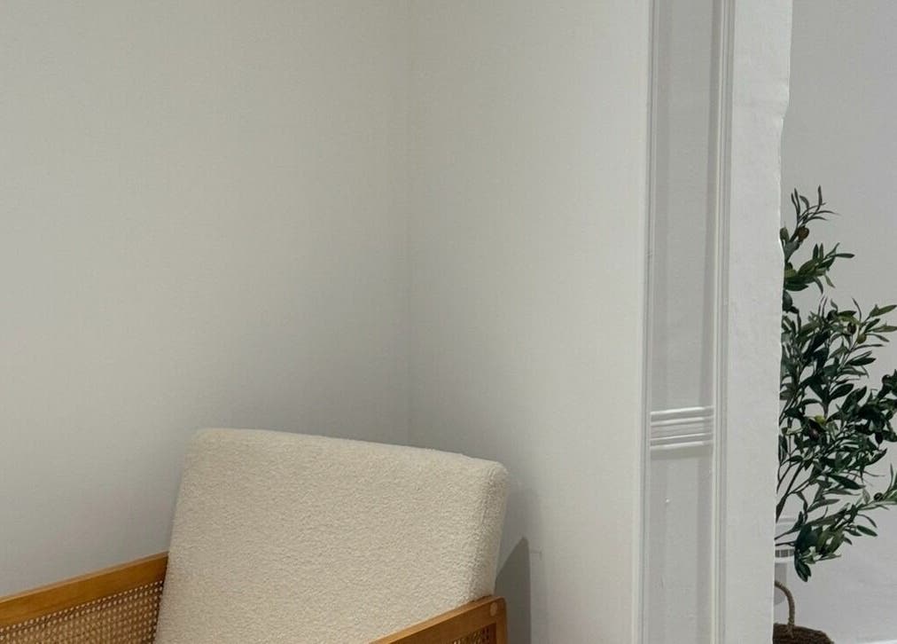 Cozy chair and plant at calma salons - Lymm, Lymm, England, GB, offering a tranquil ambiance.