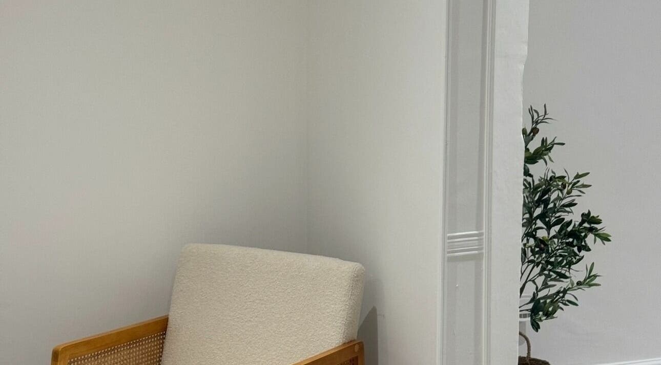 Cozy chair and plant at calma salons - Lymm, Lymm, England, GB, offering a tranquil ambiance.