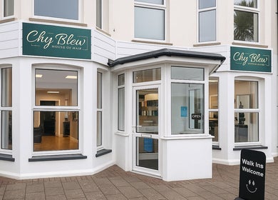 Front view of Chy Blew (House Of Hair), a stylish salon in Bude, England, GB with welcoming signs.