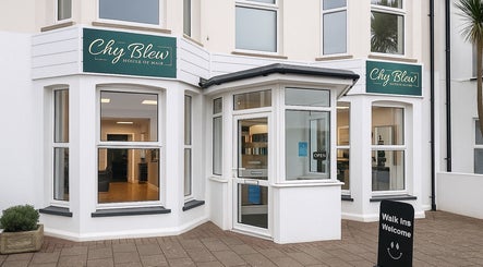 Front view of Chy Blew (House Of Hair), a stylish salon in Bude, England, GB with welcoming signs.