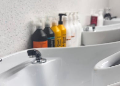 Chy Blew (House Of Hair) wash stations with shampoo bottles, Bude, England, GB.
