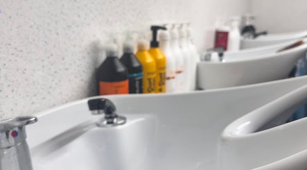 Chy Blew (House Of Hair) wash stations with shampoo bottles, Bude, England, GB.