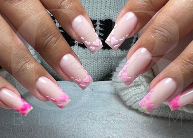 Stylish pink heart nail art at Cherry Blossom, Gönyeli, TR, showcasing intricate manicure design.
