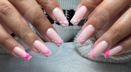 Stylish pink heart nail art at Cherry Blossom, Gönyeli, TR, showcasing intricate manicure design.